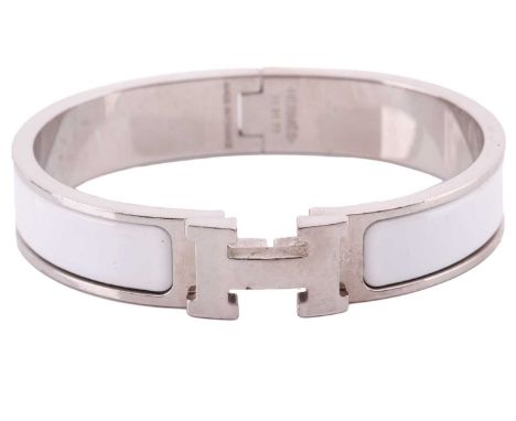 A Clic H bracelet with white enamel by Hermés of Paris, signed 'HERMÉS' total weight: 37.9 grams