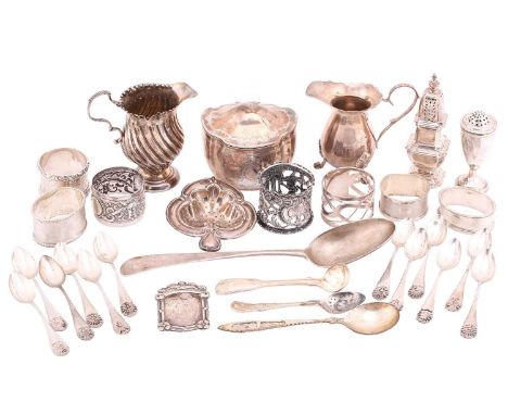 A mixed collection of items including a silver milk jug with a spirally fluted bulbous body, a silver milk jug with a bulbous