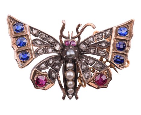 A Victorian butterfly brooch in a naturalistic design, set with rose cut diamonds, cushion shape sapphires and rubies, and ha