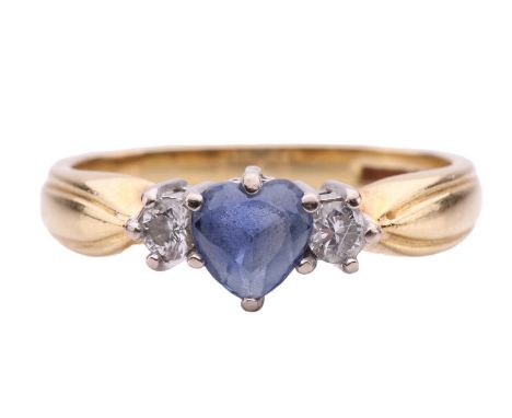 A heart sapphire and diamond dress ring in 18ct gold, centred with a heart-shaped sapphire of pale purplish-blue colour, appr