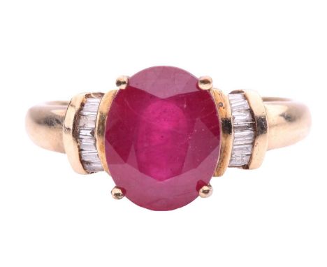 A glass-filled ruby and diamond ring, the oval glass-filled ruby measuring 10 x 8 x 4.3mm, flanked by baguette cut diamond sh
