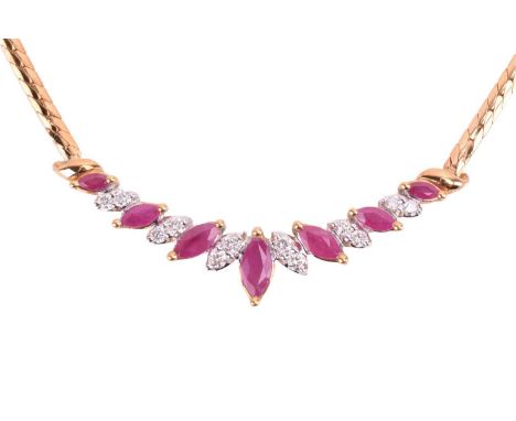 A ruby and diamond necklace in 18ct gold, alternating with graduating marquise-shaped rubies and round brilliant diamonds in 