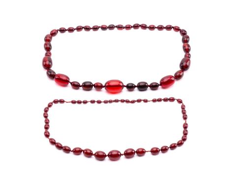 A ruby amber necklace, the oval beads graduating in size, the largest measuring 28mm x 20mm, the necklace measuring 76cm in l