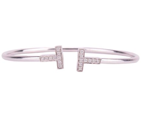 Tiffany & Co. - a Tiffany T wire bracelet in 18ct white gold, diamond-set terminals with an estimated total weight of 0.24ct,