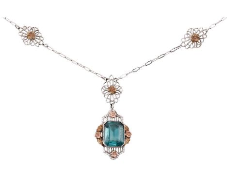 An American fine pendant necklace, the pendant set with a blue-green paste within a dainty tri-colour floral surround, to a c