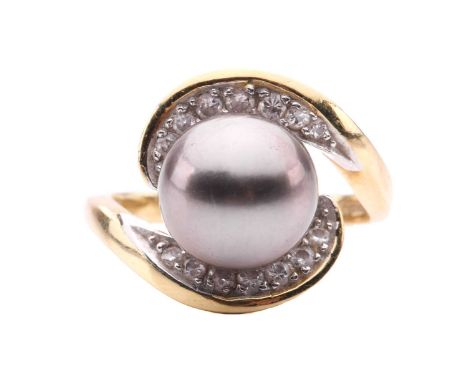 A Tahitian pearl and diamond dress ring in 18ct gold, featuring a cultured pearl of 10 mm with peacock overtones, set within 