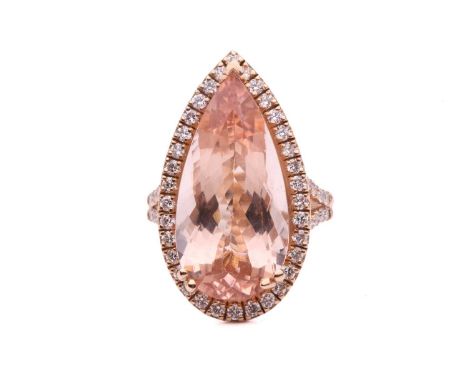 A morganite and diamond halo ring, featuring a large pear-cut morganite in pinkish-orange colour, approximately measures 21.7