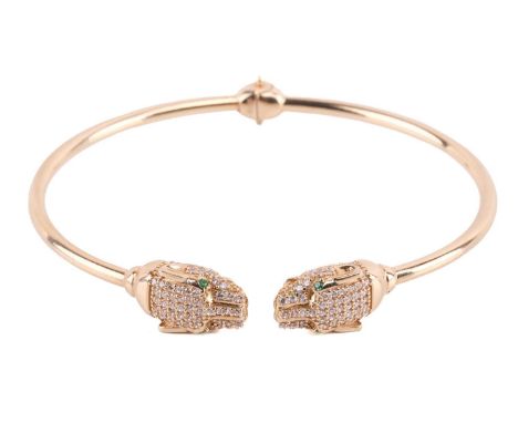 A panther torque bangle, the open-hinged bracelet terminates with panther head motifs and is decorated with cubic zirconias, 
