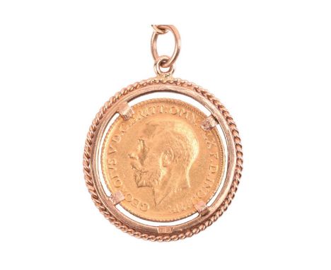 A George V full sovereign on fob chain, dated 1911, in twisted rope mount, connected to a flat mesh chain and a ring-shaped b