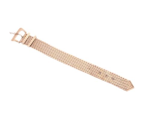 A 9ct gold jarretière slide bracelet with buckle and mordant design, the wide band is constructed by rows of articulated bric