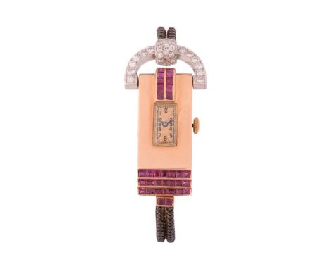 An Art Deco cocktail watch set with old cut diamonds and rubies, featuring a manual wound movement in a yellow metal case tha