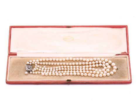 An Art Deco cultured pearl necklace with diamond clasp, comprising three rows of graduated round pearls ranging from 4.4 mm t