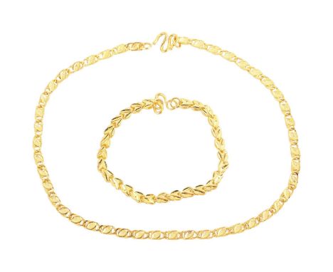 A fancy link necklace and a bracelet; the necklace with textured links finishes with S-hook clasp, yellow metal struck with m