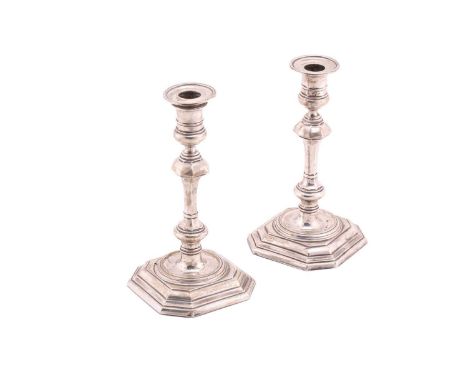 A pair of silver candlesticks with detachable octagonal sconces and weighted octagonal bases, 18cm high, Sheffield 1918.One c