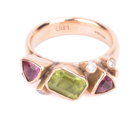 A peridot, tourmaline and diamond dress ring in 9ct gold, comprising emerald-cut peridot flanked by two trillion-cut rubellit