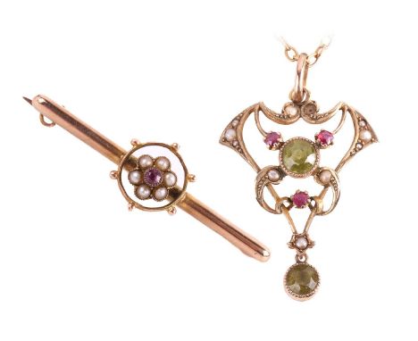 An Edwardian peridot, ruby and seed pearl pendant, marked '9ct' to the reverse, measuring 39 x 23mm, with a chain measuring 4