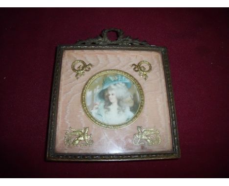 19th C picture frame with easel stand back in gilt metal regency swag frame with central circular panel on a washed silk back
