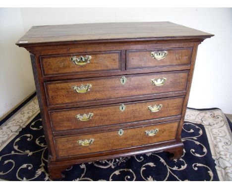 Early 19th C oak and cross banded chest of two short above three long drawers on raised bracket supports (106cm x 56cm x 96cm