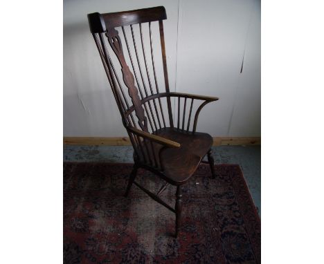 Quality Craftsman made copy of a elm high stick back Windsor type armchair with pierced central splat, turned supports and H 