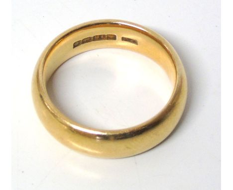 An 18ct gold band ring, hallmarks for Birmingham, ring size T1/2, gross weight 13.5g. Condition reports are not available for