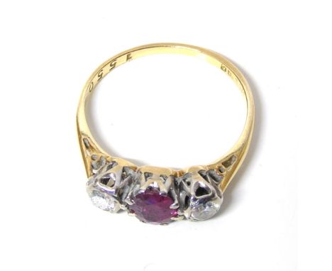 An 18ct gold ruby and diamond three stone ring, ring size M1/2, gross weight 2.3g.Condition reports are not available for our