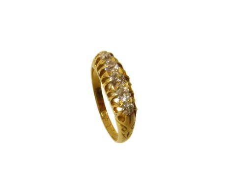 An early 20th Century diamond five stone ring, the old cut diamond line with scrolling shoulders, estimated total diamond wei