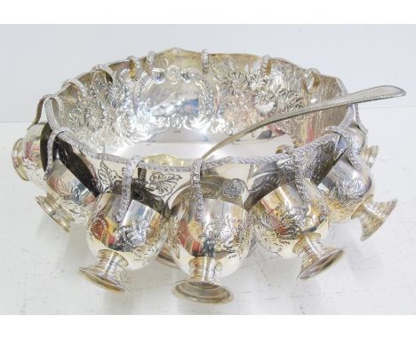 Silver plated punch bowl with fourteen cups and a ladle. Condition reports are not available for our Interiors Sales
