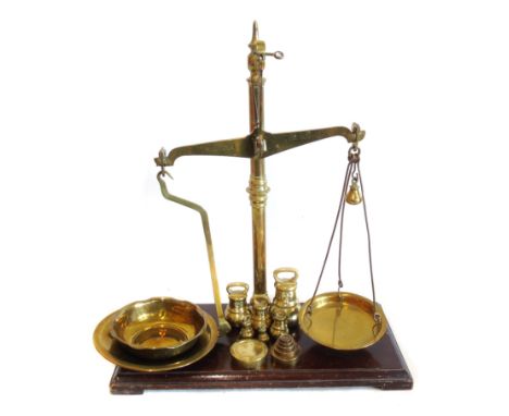 Set of W and T Avery brass scales on mahogany base with two sets of weights, 59cm high. Condition reports are not available f