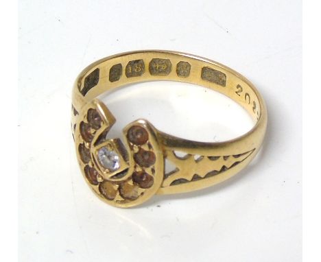 An 18ct gold diamond horseshoe ring, the old cut diamond with horseshoe surround and openwork shoulders, hallmarks for Birmin