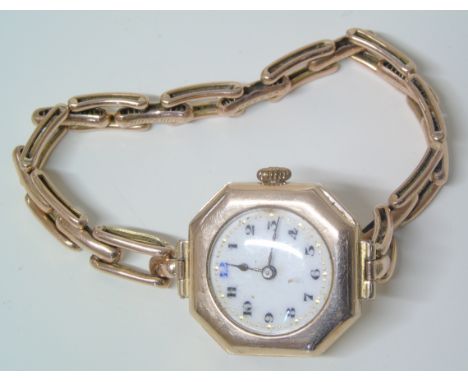 An early 20th century 9ct gold cased wristwatch, the circular white enamel dial with Arabic hour markers, 15 jewel movement w