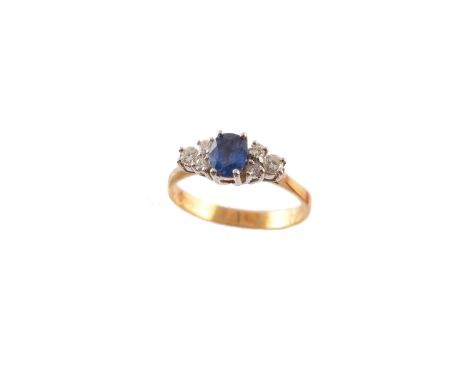 An 18ct gold sapphire and diamond dress ring, the oval shape sapphire with brilliant cut diamond trefoil sides, estimated tot