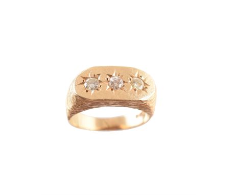 A 9ct gold diamond three stone ring, designed as a trio of circular and brilliant cut diamonds, star set within the oval pane