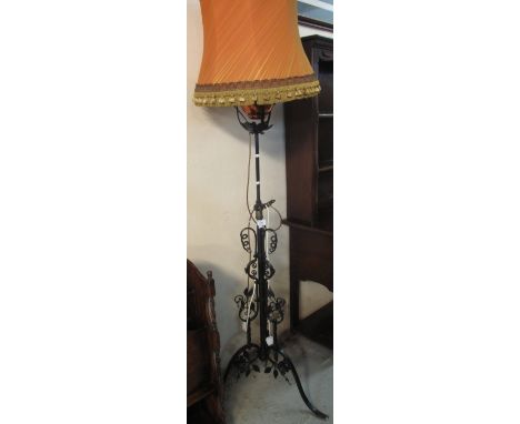 Cast metal scroll decorated standard lamp on triform base with shade. (B.P. 24% incl. VAT)