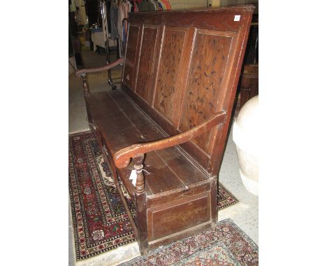 Large 18th Century panelled backed settle, the four raised and fielded panels copiously inlaid with trailing foliate designs,