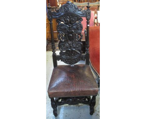 17th Century style stained, carved oak hall chair with leather seat.(B.P. 24% incl. VAT)