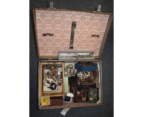 Vintage suitcase containing assorted costume jewellery including: beads; bar brooches, including: arrow design bar brooch; fl