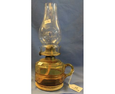 Early 20th Century single burner oil chamber stick with amber glass reservoir, clear funnel. (B.P. 24% incl. VAT)