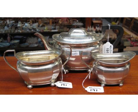 Three piece silver tea set comprising teapot; twin handled sucrier and cream jug, all raised on four bun type feet, Sheffield