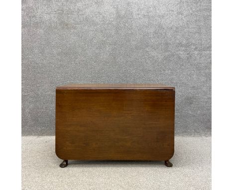 A 19th century Georgian style mahogany drop leaf table having a rectangular top over a moulded frieze on cabriole supports wi