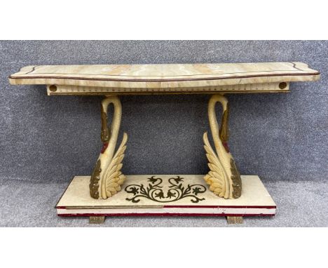 An Art Deco console table with an inlaid onyx serpentine fronted top over a fluted and gilt frieze, raised on a pair of paint