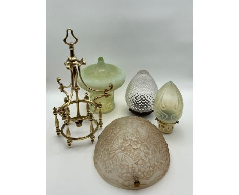 A C.1900 Art Nouveau brass pendant light with a vaseline glass shade etched allover with scrolling foliate designs with an in