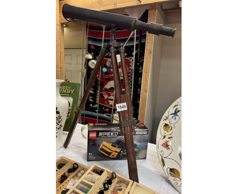 A patinated brass telescope on teak tripod, length 44cm