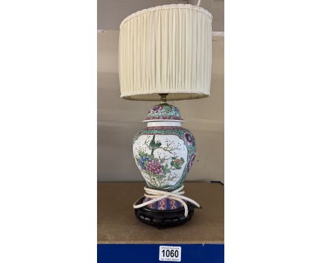 A Chinese style table lamp with shade.