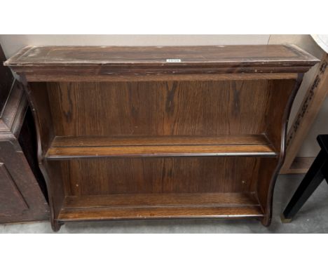 A dark oak wall hanging plate rack/shelf unit