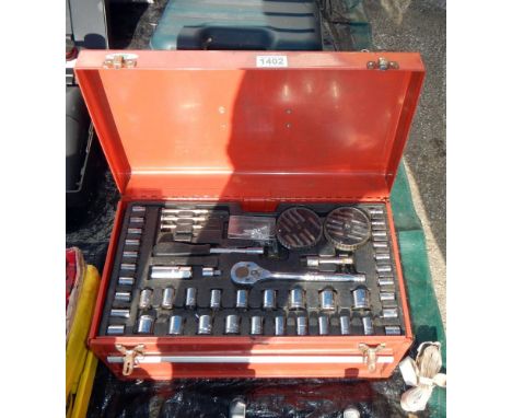 A metal tool box with drawer containing socket set &amp; spanners