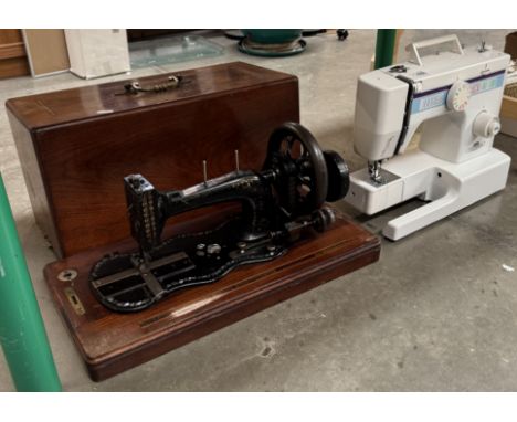 A Victorian cast iron sewing machine decorated with mother of pearl &amp; An electric sewing machine with no leads