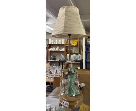A vintage ceramic table lamp of a seated lady