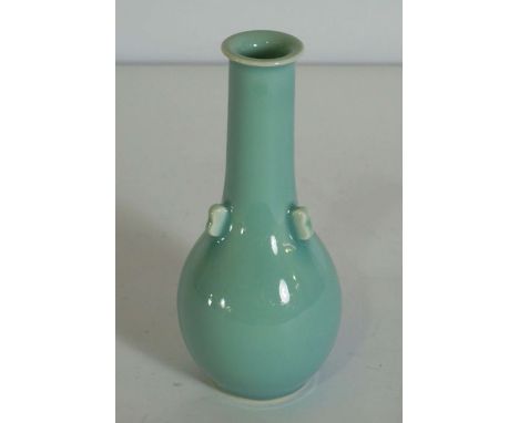 A Chinese porcelain monochrome vase, 20th century, with a light blue glaze, the body with three lugs to the neck, single char