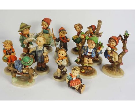 A group of twelve assorted Goebel &amp; Hummel figurines, including Skier &amp; Apple Tree Boy (12)
