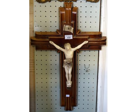 An early 20th Century brown glazed ceramic model depicting Christ on the cross.